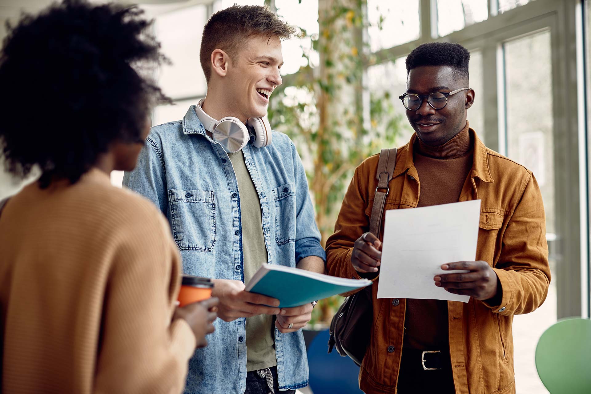 group-of-happy-college-students-talking-while-read-2023-11-27-05-09-52-utc.jpg